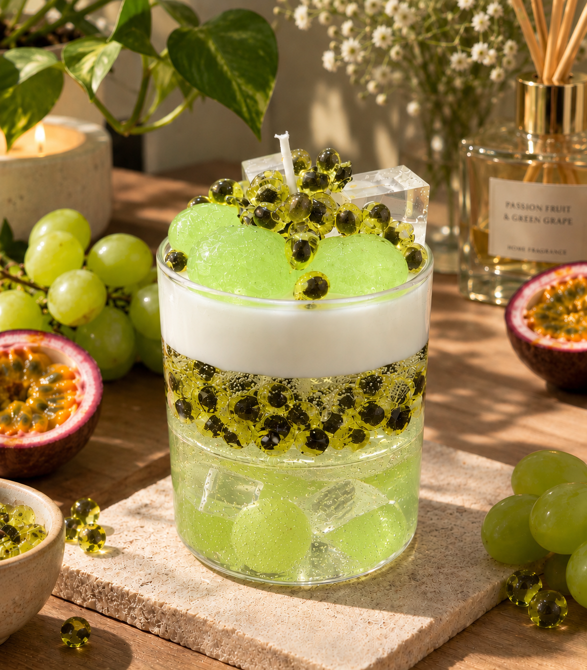 Pairsense Passion Fruit and Green Grape scented candle, pale green wax with grape spheres under a cap of cream in a clear glass jar
