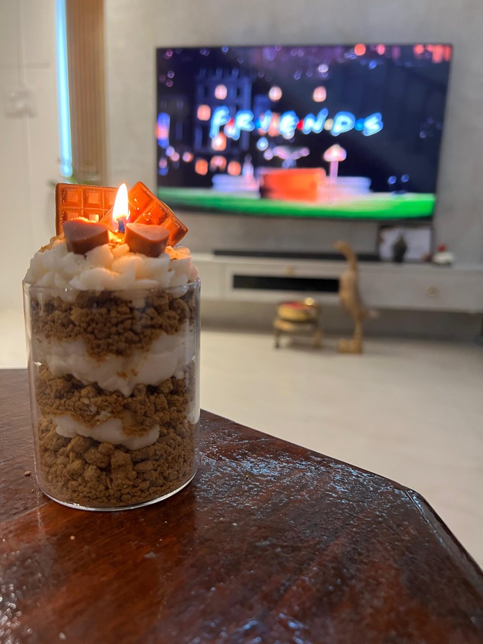 A customer's Pairsense Chocolate Heart candle, layered crumble and cream under chocolate hearts, lit in a living room