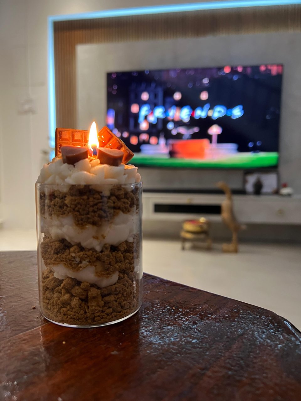 A customer's Pairsense Chocolate Heart candle, layered crumble and cream under chocolate hearts, lit in a living room